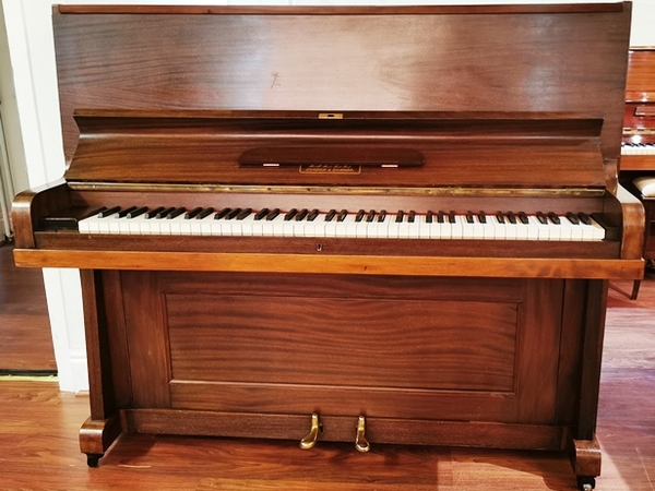Bell pre-owned upright piano.